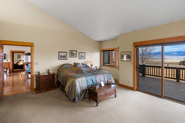 bedroom featuring access to outside, light colored carpet, baseboards, and high vaulted ceiling