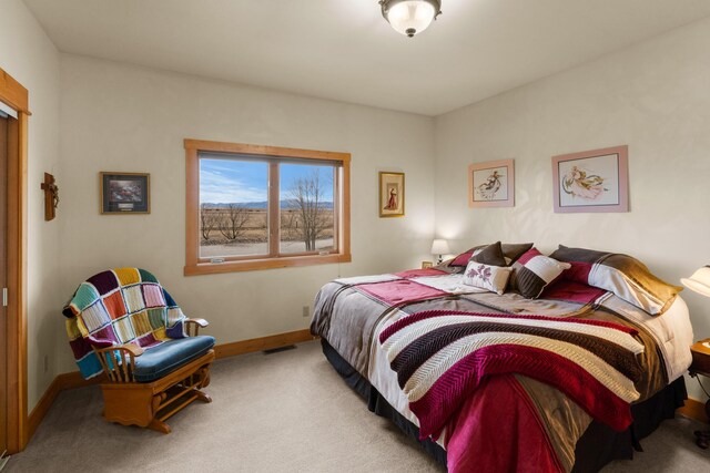 bedroom with carpet flooring and baseboards
