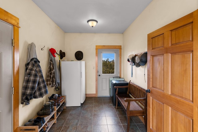 mudroom featuring dark tile patterned flooring