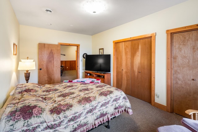 carpeted bedroom featuring two closets