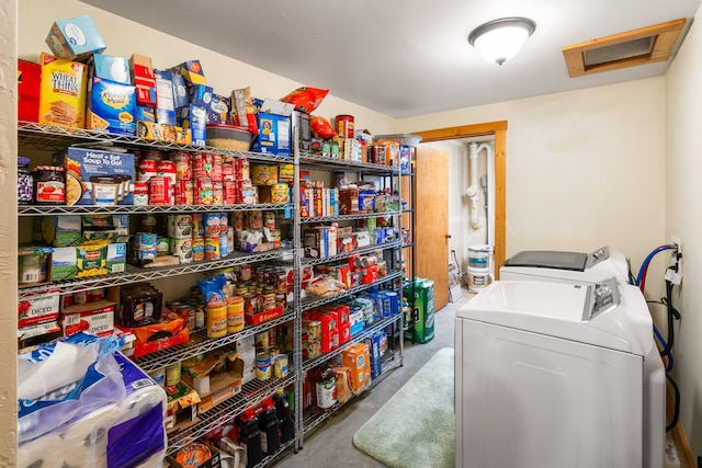 washroom featuring washer and dryer, laundry area, and attic access