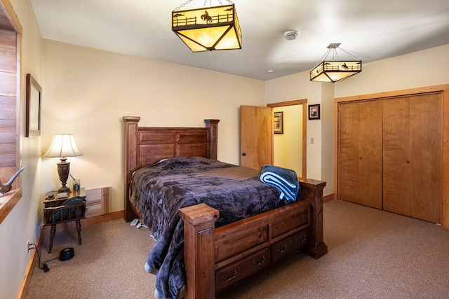 bedroom with carpet, a closet, and baseboards