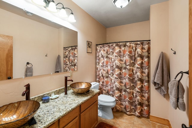 bathroom featuring vanity, curtained shower, toilet, and tile patterned flooring