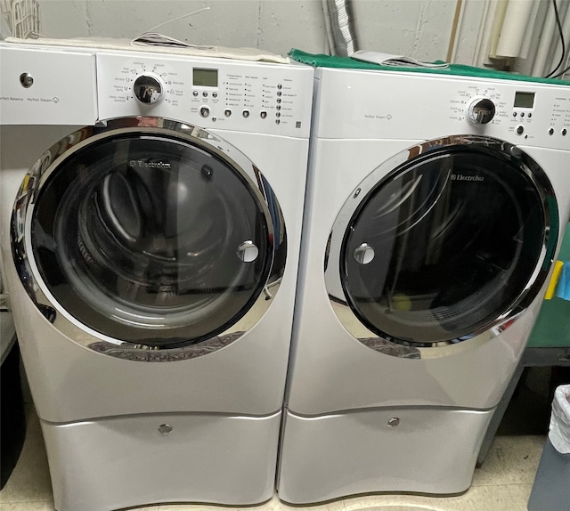 washroom featuring laundry area and washer and dryer