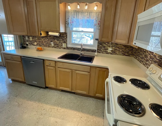 kitchen with backsplash, white appliances, light countertops, and a sink