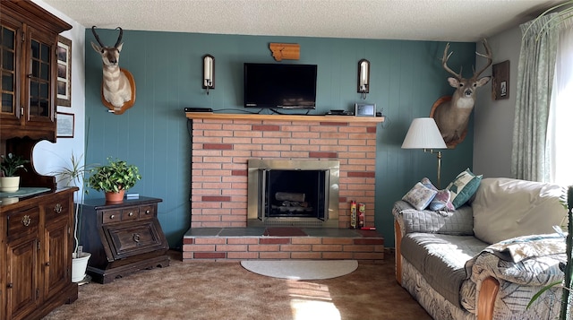 carpeted living area with a fireplace and a textured ceiling