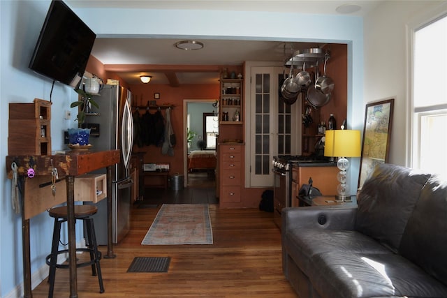 living area with visible vents and wood finished floors