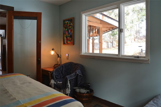 bedroom featuring freestanding refrigerator