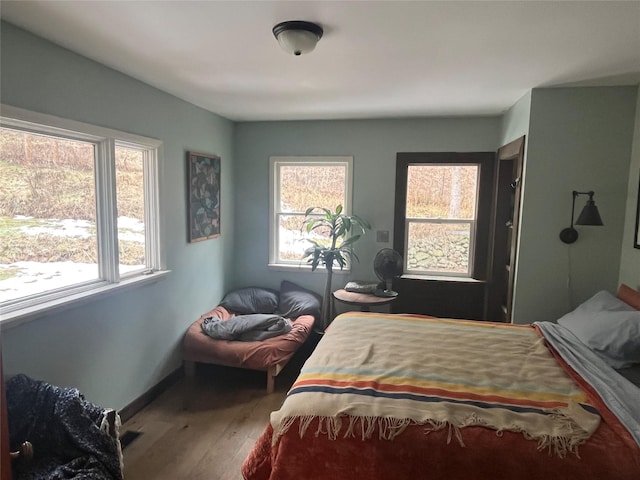 bedroom with baseboards and wood finished floors