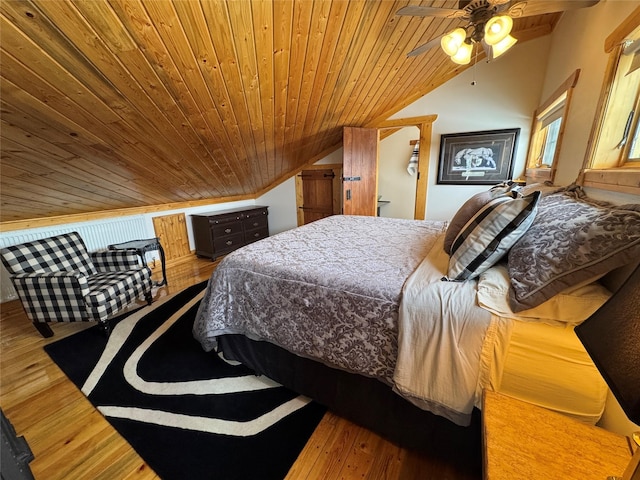 bedroom with ceiling fan, wood ceiling, wood finished floors, and vaulted ceiling