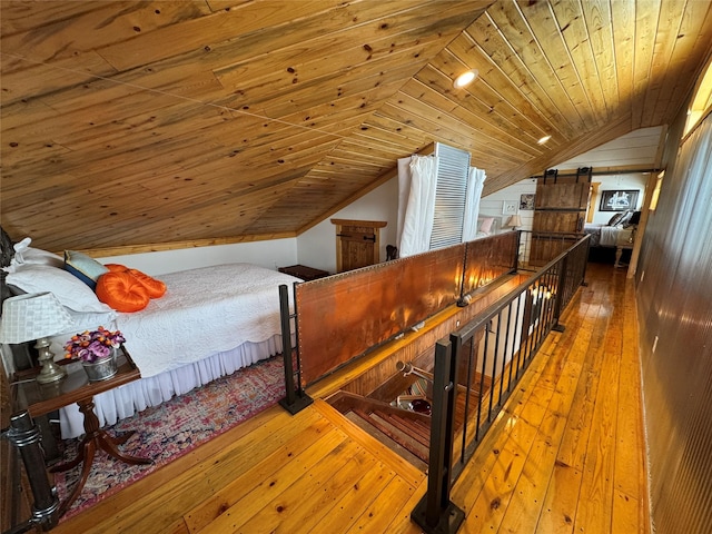 bedroom featuring wood walls, wooden ceiling, lofted ceiling, and hardwood / wood-style floors