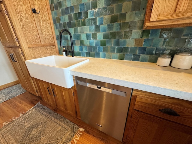 bathroom with a sink, backsplash, and wood finished floors