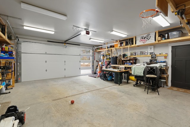 garage with a workshop area and a garage door opener