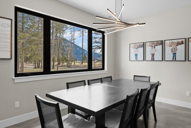 dining room with a chandelier and baseboards