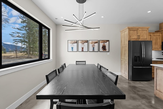 dining space featuring visible vents, baseboards, concrete floors, recessed lighting, and a notable chandelier