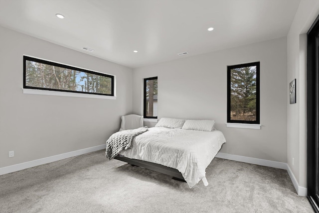 carpeted bedroom with recessed lighting, visible vents, and baseboards