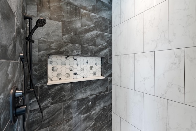 interior details featuring a tile shower