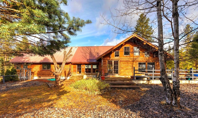 view of front of property featuring metal roof, fence, and crawl space