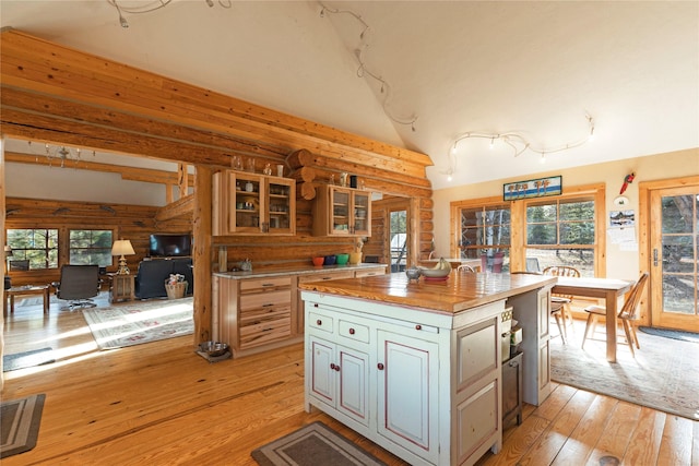 17 Mountain View Rd, Trout Creek, MT 59874 - kitchen with light wood-style flooring, butcher block counters, rustic walls, healthy amount of natural light, and glass insert cabinets