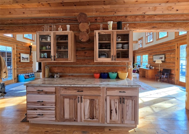 17 Mountain View Rd, Trout Creek, MT 59874 - kitchen with rustic walls, light wood-style flooring, glass insert cabinets, and light stone countertops