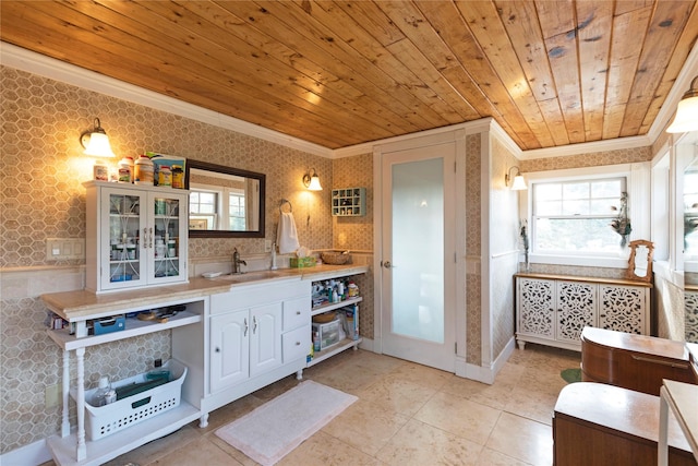 17 Mountain View Rd, Trout Creek, MT 59874 - kitchen featuring wallpapered walls, crown molding, wooden ceiling, light countertops, and glass insert cabinets