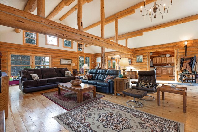 17 Mountain View Rd, Trout Creek, MT 59874 - living area featuring rustic walls, high vaulted ceiling, beam ceiling, light wood-style floors, and a chandelier