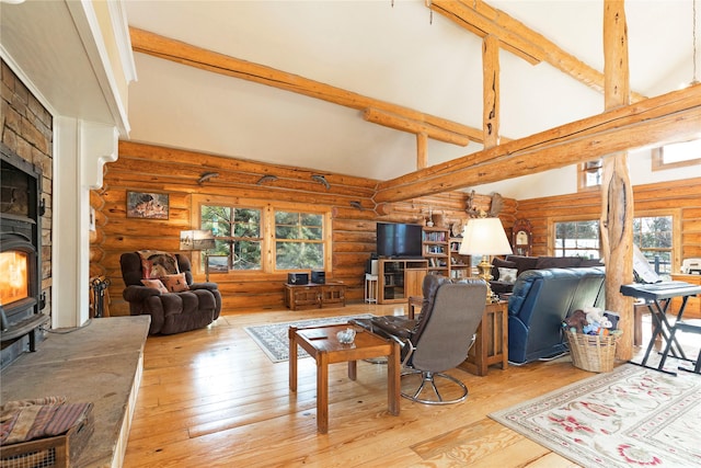 17 Mountain View Rd, Trout Creek, MT 59874 - living room featuring rustic walls, a wood stove, wood-type flooring, beam ceiling, and high vaulted ceiling