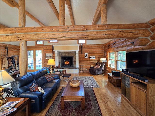 17 Mountain View Rd, Trout Creek, MT 59874 - living area featuring rustic walls, high vaulted ceiling, light wood finished floors, beam ceiling, and a stone fireplace
