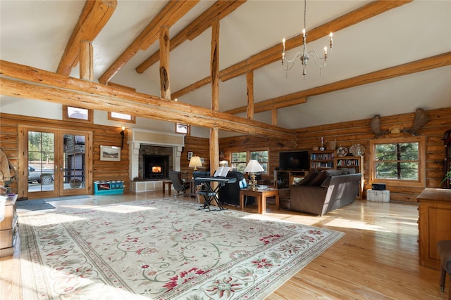 17 Mountain View Rd, Trout Creek, MT 59874 - living room featuring rustic walls, beamed ceiling, a fireplace with raised hearth, wood finished floors, and french doors