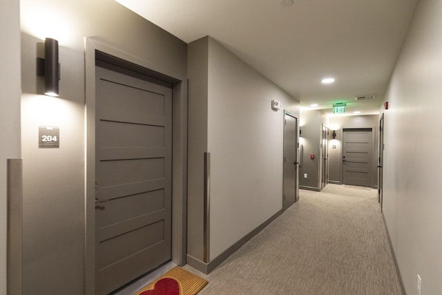 hallway featuring recessed lighting, visible vents, baseboards, and light colored carpet