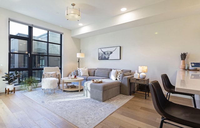 living room with recessed lighting and light wood-style floors