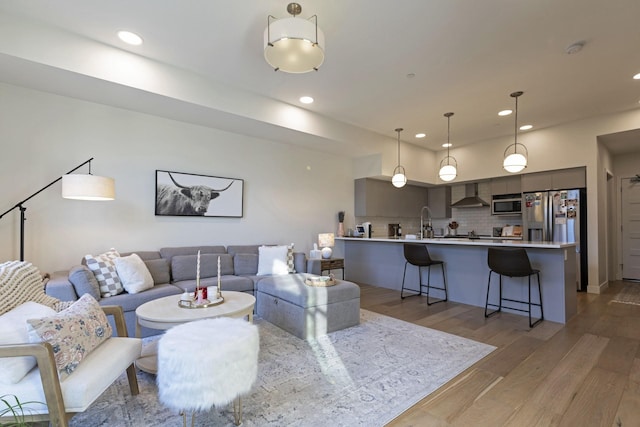 living room featuring light wood-style flooring and recessed lighting