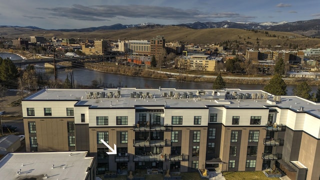 birds eye view of property with a water and mountain view