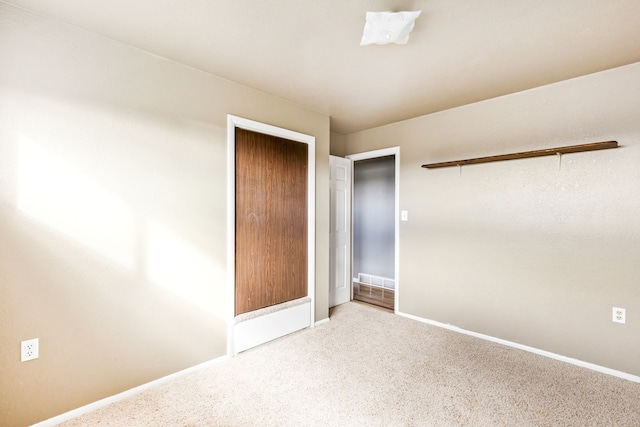 unfurnished bedroom featuring baseboards and carpet