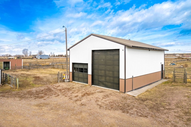 view of pole building featuring a rural view and fence