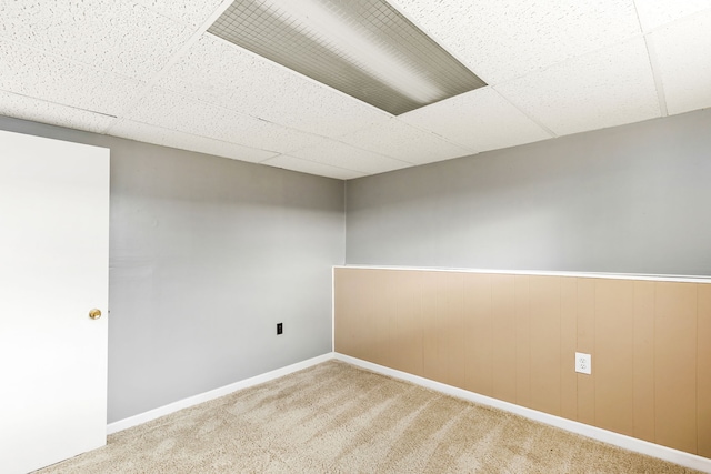 spare room featuring wainscoting, a paneled ceiling, and carpet floors