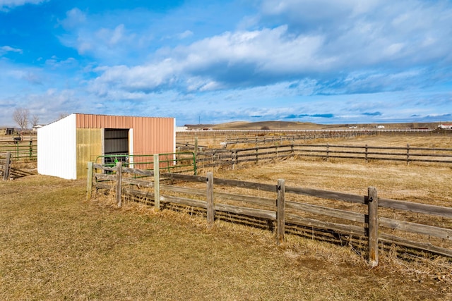 view of yard with an exterior structure, an outbuilding, and a rural view