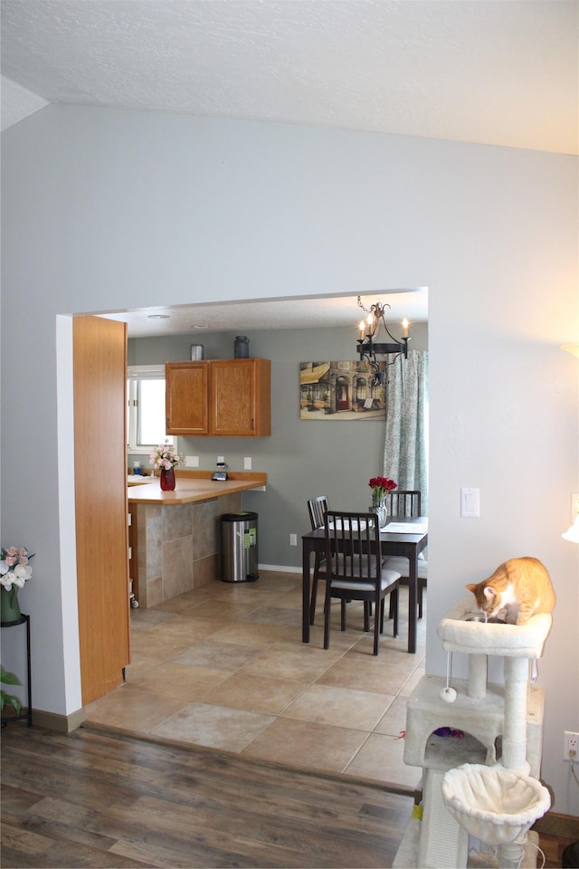 3004 Green Cir, Butte, MT 59701 - dining space with vaulted ceiling, a chandelier, baseboards, and light wood finished floors