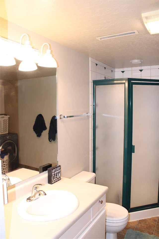 3004 Green Cir, Butte, MT 59701 - full bathroom with a shower stall, toilet, vanity, and washer / dryer