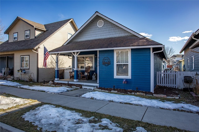 bungalow with a porch and fence