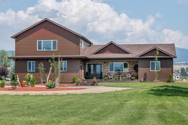 view of front of property with a front yard and french doors