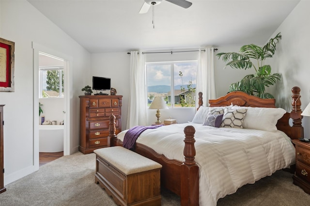 carpeted bedroom featuring baseboards, a ceiling fan, and vaulted ceiling