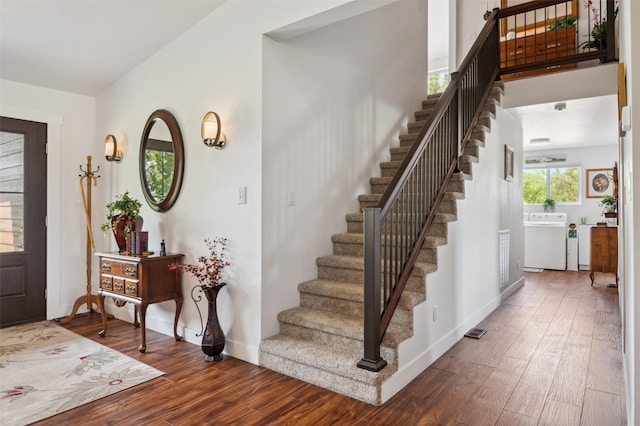 foyer entrance featuring visible vents, baseboards, and wood finished floors