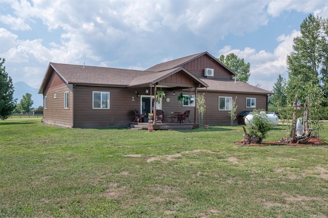 rear view of property with a yard