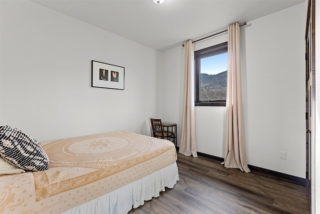 bedroom with wood finished floors and baseboards