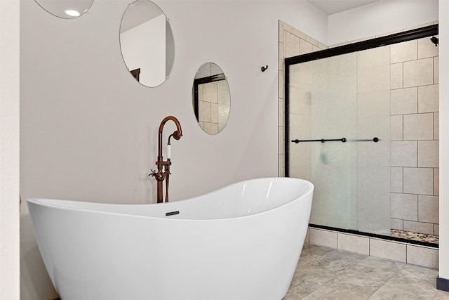 bathroom with a freestanding bath and a tile shower