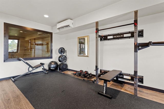 workout area featuring recessed lighting, baseboards, and a wall mounted AC