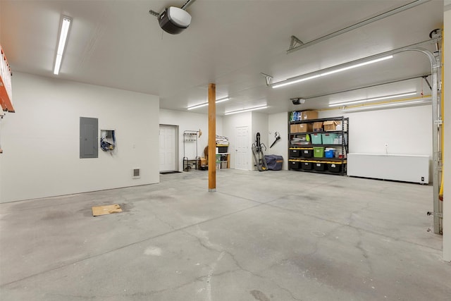 garage featuring electric panel and a garage door opener