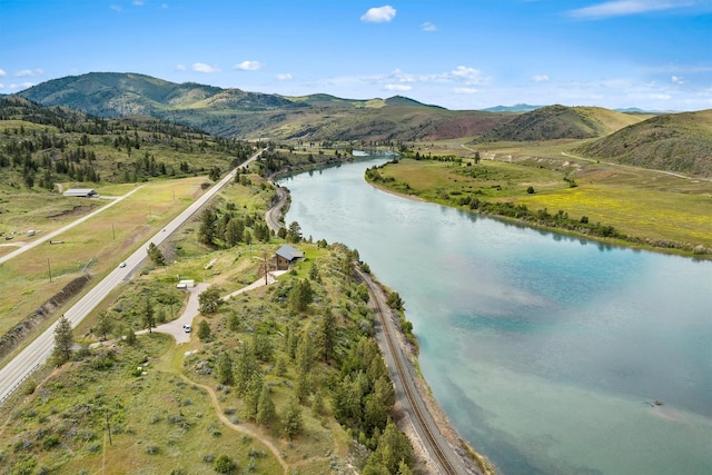 drone / aerial view with a water and mountain view