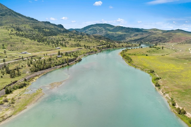 drone / aerial view with a water and mountain view